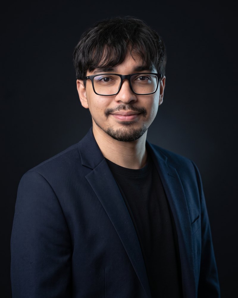 Robson Luiz, desenvolvedor de sites, de blazer azul-marinho sobre fundo escuro